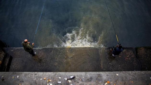 People fish next to a sewage overflow pipe emptying into the Mediterranean Sea. Fisherman Ahmad Obeitri has been a fixture at Lebanon’s corniche — a popular seaside promenade in central Beirut — for the past 30 years. He says the trash is killing off what’s left of marine life. (Hassan Ammar / AP) People fish next to a sewage overflow pipe emptying into the Mediterranean Sea. Fisherman Ahmad Obeitri has been a fixture at Lebanon’s corniche — a popular seaside promenade in central Beirut — for the past 30 years. He says the trash is killing off what’s left of marine life. (Hassan Ammar / AP)
