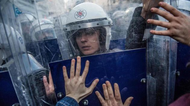 A Turkish female riot police officer reacts during clashes with women’s rights activists as they try to march to Taksim Square to protest against gender violence in Istanbul, on the International Day for the Elimination of Violence against Women. (Bulent Kilic / AFP) A Turkish female riot police officer reacts during clashes with women’s rights activists as they try to march to Taksim Square to protest against gender violence in Istanbul, on the International Day for the Elimination of Violence against Women. (Bulent Kilic / AFP)