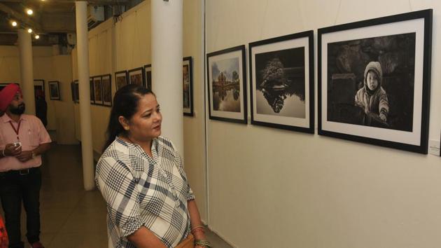 A woman takes a look at a photography exhibition in Chandigarh.(HT File)