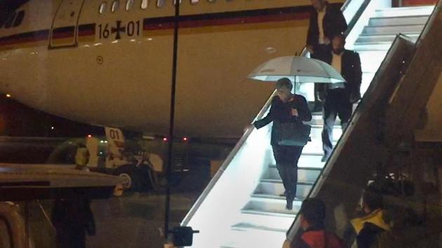 German Chancellor Angela Merkel steps down from Airbus "Konrad Adenauer" on late November 29, 2018 on the tarmac of Cologne's airport after an emergency landing.(AFP Photo)