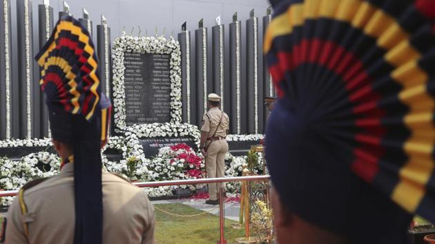 Police officers pay tribute to the victims of the Mumbai terror attacks at a memorial in Mumbai, Maharashtra on Monday, November 26, 2018. (Rafiq Maqbool / AP)