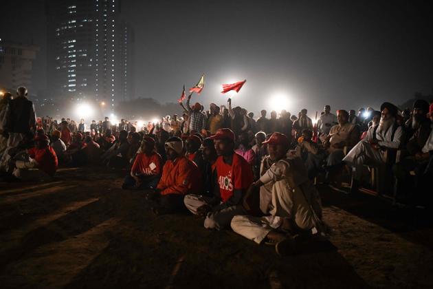 The farmers converged in the national capital on Thursday at the Ramlila maidan, known for hosting big political events over the years. The location resonated with slogans like ‘Ayodhya nahi, karz maafi chahiye’ as farmers wearing red caps and carrying red flags started to gather. (Chandan Khanna / AFP)