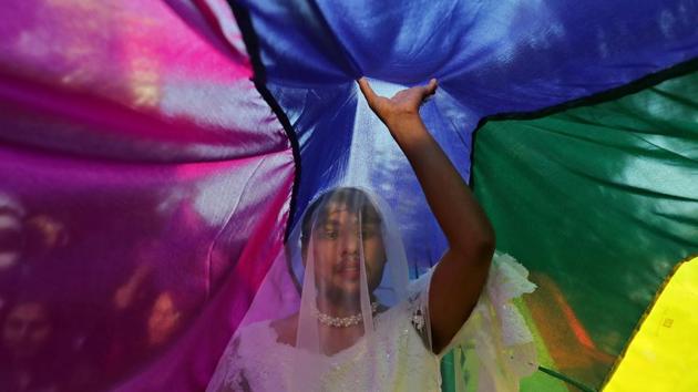 A participant touches a rainbow flag during the Queer Pride March, an event promoting gay, lesbian, bisexual and transgender rights, in New Delhi on November 25, 2018. (Anushree Fadnavis / REUTERS)