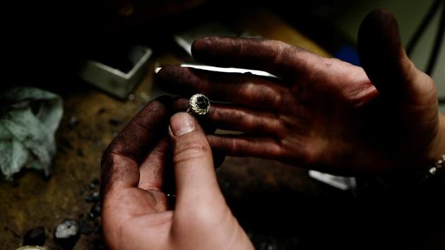 Katarzyna Depa, 26, who makes jewellery from coal, holds a silver ring at her atelier in Katowice, Poland. “For me using coal in a different way than it used to be, which was energy, shows its completely new face, so we can call it our new, cool black gold,” said Depa. (Kacper Pempel / REUTERS) Katarzyna Depa, 26, who makes jewellery from coal, holds a silver ring at her atelier in Katowice, Poland. “For me using coal in a different way than it used to be, which was energy, shows its completely new face, so we can call it our new, cool black gold,” said Depa. (Kacper Pempel / REUTERS)