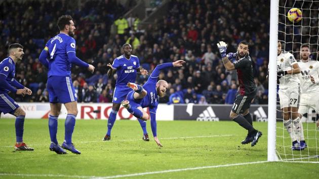 Cardiff City's Aron Gunnarsson, center, scores his side's first goal of the game during their Premier League soccer match against the Wolverhampton Wanderers at Cardiff City Stadium.(AP)