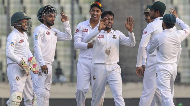 Bangladesh's Mehedi Miraz (C) celebrate with teammates after the dismissal of West Indies Shai Hope.(AFP)