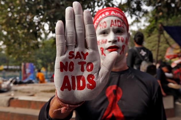 A man poses as he displays his hand and face painted with messages during an HIV/AIDS awareness campaign on the eve of World AIDS Day.(PICTURE FOR REPRESENTATIONAL PURPOSES ONLY)