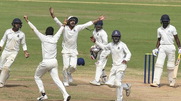 Bengal team bowler Writtick Bijoy Chatterjee celebrate with his teammates after taking the wicket of Tamil Nadu batsman B Anirudh on the 3rd of the Ranji Trophy cricket match, at MAC Stadium.(AP)