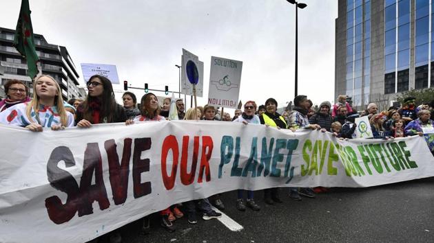 Demonstrators hold a banner which reads 'save our planet, save our future' during a 'Claim the Climate' march in Brussels, Sunday, Dec. 2, 2018. The climate change conference, COP24, will take place in Poland from Dec. 2-14. (AP Photo/Geert Vanden Wijngaert)(AP)