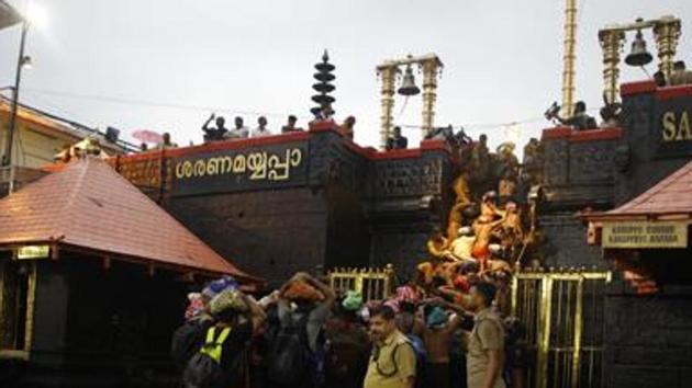 In the file photo, devotees can be seen climbing over the holy eighteen golden steps to worship Lord Ayyapa at Sabarimala(Vivek Nair / HT Photo)