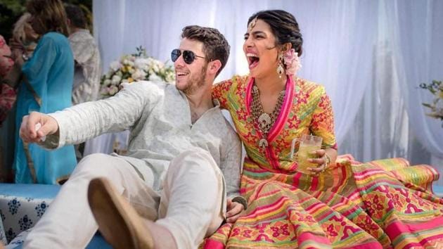 Bollywood actor Priyanka Chopra and American singer Nick Jonas celebrate during their mehendi ceremony, a day before their wedding, at Umaid Bhawan in Jodhpur.(PTI)