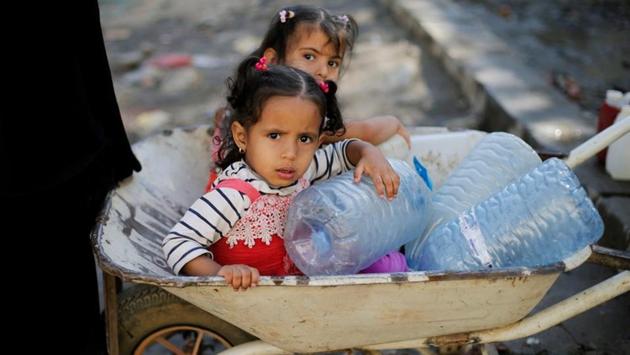 Girls wait next to a charity tap. More than 250,000 cases of cholera have been recorded in Yemen since the beginning of 2018, with 358 associated deaths, UNICEF representative Meritxell Relano told Reuters. “We have prevented an outbreak at the scale of 2017,” Relano said. “But the risk is still there.” (Khaled Abdullah / REUTERS) 