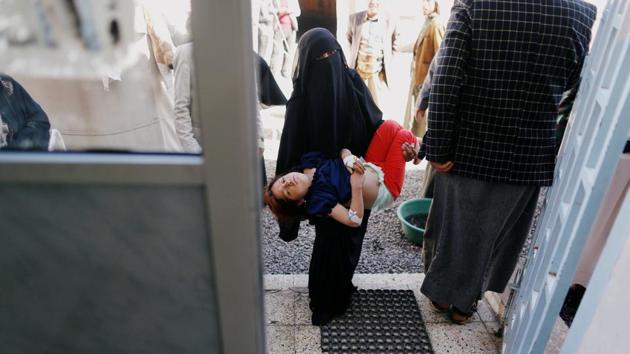 A woman carries her cholera-infected daughter to a treatment ward. Pediatrician Mohammed Abdulmughni works with children in WHO tents in Sanaa. Their beds rest on gravel and flies circle their faces. “With winter’s arrival we expected the numbers would decrease, yet the cases have been coming in at the same pace,” he said. “We expected positive (diagnoses) cases to decrease but the cases remain high.” (Khaled Abdullah / REUTERS) 