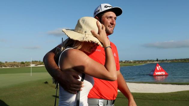 Jon Rahm Spain walks off the 18th green with fiancee Kelley Cahill after winning the Hero World Challenge in Bahamas.(AFP)