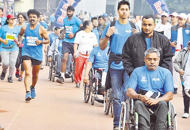 Physically challenged participants also participated with their wheel chair in the Pune International Marathon on Sunday.(Shankar Narayan/HT PHOTO)