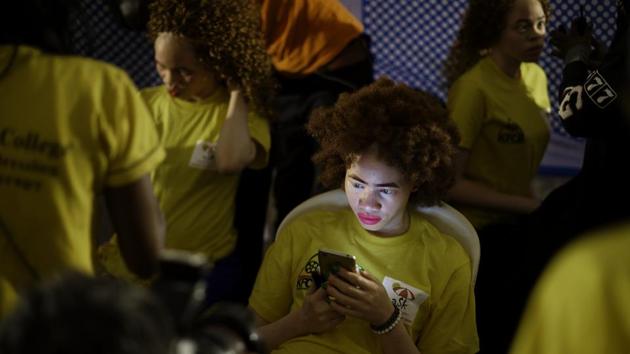 A contestant waits to have her makeup done backstage. Contestants said they saw the groundbreaking event as a way to end discrimination, violence and even murder of people with albinism because of their hereditary lack of pigmentation. (Ben Curtis / AP)
