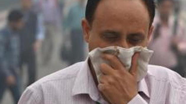 A pedestrian covers his face for protection against air pollution in New Delhi. The Air Quality Index (AQI) dropped from 306 on Saturday to 294 on Sunday, bringing the capital under the “poor” category. (PTI File /) A pedestrian covers his face for protection against air pollution in New Delhi. The Air Quality Index (AQI) dropped from 306 on Saturday to 294 on Sunday, bringing the capital under the “poor” category. (PTI File /)