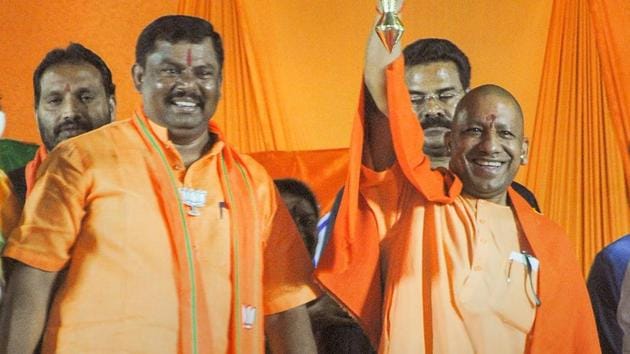 Yogi Adityanath (right) was addressing an election rally in Goshamahal constituency in Hyderabad in support of BJP candidate T Raja Singh Lodh (left).(PTI)