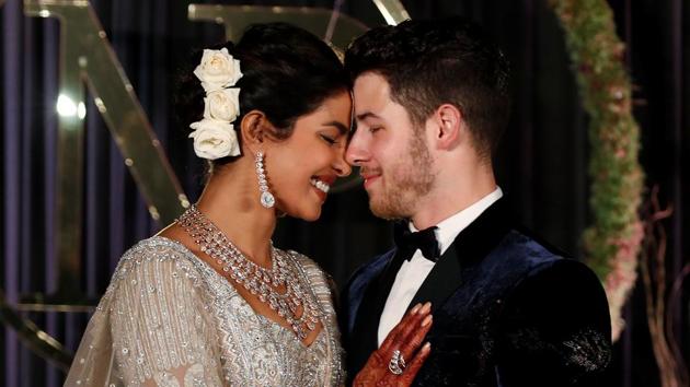 Bollywood actor Priyanka Chopra and her husband singer Nick Jonas pose during a photo opportunity at their wedding reception.(REUTERS)