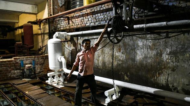 An Indian labourer fills cans with water to freeze into ice at an ice factory in Noida. Image for representation (AFP file photo) An Indian labourer fills cans with water to freeze into ice at an ice factory in Noida. Image for representation (AFP file photo)