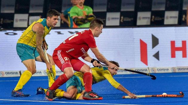 Bhubaneswar: England player (red) Liam Ansell and Australia 's Jake Whetton vie for the ball during a match, in Men's Hockey World Cup 2018, at Kalinga Stadium in Bhubaneswar, Tuesday, Dec 4, 2018.(PTI) Bhubaneswar: England player (red) Liam Ansell and Australia 's Jake Whetton vie for the ball during a match, in Men's Hockey World Cup 2018, at Kalinga Stadium in Bhubaneswar, Tuesday, Dec 4, 2018.(PTI)