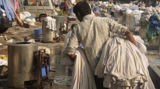 Once cleaned, the clothes get a spin in the hydro --a manually operated machine that wrings out water. Its large steel drum is spun with a hand roller on the side. It takes under an hour to dry out a batch which is then laid out in the sun. It’s only during the monsoon that the drying turns a bit difficult. (Samir Jana / HT Photo) Once cleaned, the clothes get a spin in the hydro --a manually operated machine that wrings out water. Its large steel drum is spun with a hand roller on the side. It takes under an hour to dry out a batch which is then laid out in the sun. It’s only during the monsoon that the drying turns a bit difficult. (Samir Jana / HT Photo)