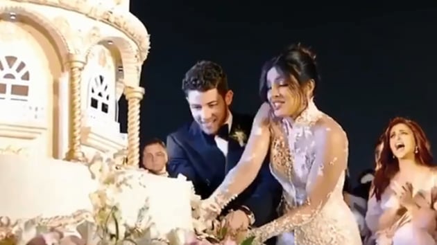 Priyanka Chopra and Nick Jonas cut their 18-foot wedding cake.