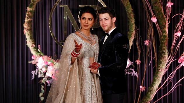 Priyanka Chopra and her husband singer Nick Jonas pose during a photo opportunity at their wedding reception in New Delhi. Twitter is defending Priyanka against a ‘racist’ article published in a US magazine.(REUTERS)