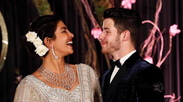 Bollywood actor Priyanka Chopra and her husband singer Nick Jonas pose during a photo opportunity at their wedding reception in New Delhi.(REUTERS)