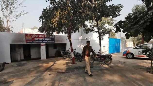 A police officer walks in the premises of a police station that was partially damaged by a mob during a protest on Monday in Chingrawti village of Bulandshahr district in Uttar Pradesh.(REUTERS)