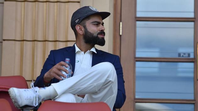 India skipper Virat Kohli waits for Australia captain Tim Paine for a photo shoot with the Border Gavaskar trophy. (AFP) India skipper Virat Kohli waits for Australia captain Tim Paine for a photo shoot with the Border Gavaskar trophy. (AFP)