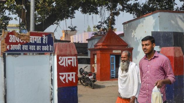 A sadhu walks past a police station, on the eve of the anniversary of Babri mosque demolition, in Ayodhya.(PTI Photo)