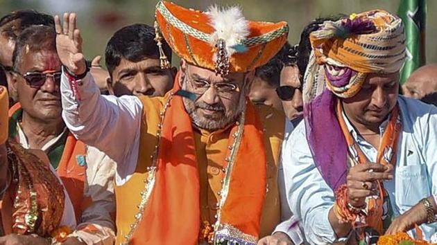 BJP President Amit Shah waves at supporters at an election roadshow .(PTI file photo) BJP President Amit Shah waves at supporters at an election roadshow .(PTI file photo)