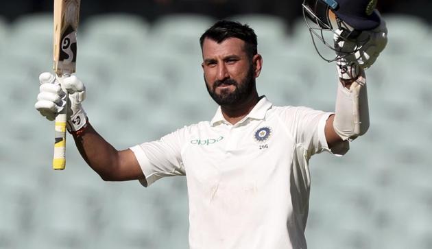 Cheteshwar Pujara celebrates after reaching a century during the first Test between Australia and India in Adelaide. (AP)