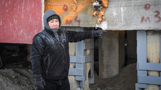 Eduard Romanov points to a spot on a block of flats where a major supporting beam has sagged and begun to crack, destabilising the nine storeys of apartments above. “Since the year before last, the building has started to list and has tilted about 16 inches,” says Romanov, a construction worker and environmental activist. (Mladen Antonov / AFP) Eduard Romanov points to a spot on a block of flats where a major supporting beam has sagged and begun to crack, destabilising the nine storeys of apartments above. “Since the year before last, the building has started to list and has tilted about 16 inches,” says Romanov, a construction worker and environmental activist. (Mladen Antonov / AFP)