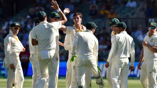 Australia's paceman Pat Cummins (C) celebrates with teammates after dismissing India's batsman Ravichandran Ashwin. (AFP) 
