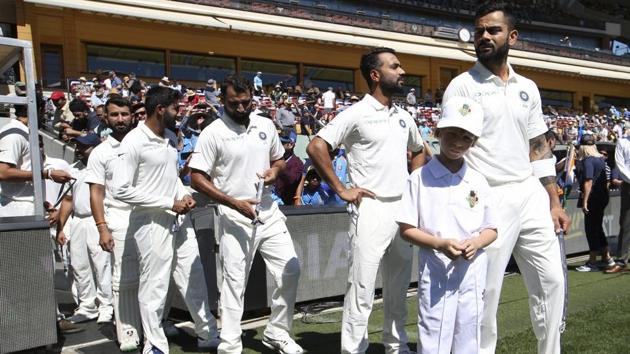 Virat Kohli leads his players out on to the field ahead of play of the first Test between Australia and India in Adelaide. (AP) 