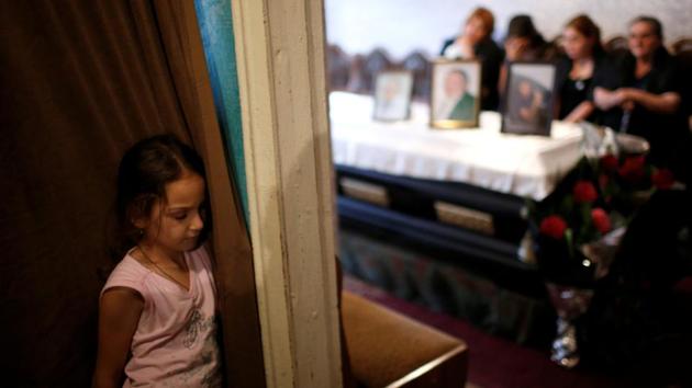 Lizi, 8, mourns at the casket of her grandfather Mikheil Gamezardashvili, 55, a miner who died during an accident at the Mindeli mine in July. In all, 32 miners have died in accidents at the Mindeli mine in Tkibuli, 200 km west of the capital Tbilisi, over the past decade and most local men acknowledge that if they could find other work they would do. (David Mdzinarishvili / REUTERS)