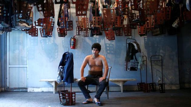 Miner David Tsnobiladze, 20, rests in a changing room at the Mindeli mine. David has worked at the mine for two years. His father has worked at the mine for 20 years and his grandfather worked there for 34 years. Tsnobiladzes believes the mine is the main part of the town. “It is the spine. Without the mine, the town would not exist,” he said. (David Mdzinarishvili / REUTERS)