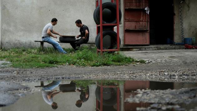 Men play backgammon on a street in Tkibuli. That momentum came to a halt with the collapse of the Soviet Union in 1991. Textile workshops, a lemonade-producing factory and other small businesses were closed, leaving the mine as almost the only job option for locals now living in an independent state. (David Mdzinarishvili / REUTERS)