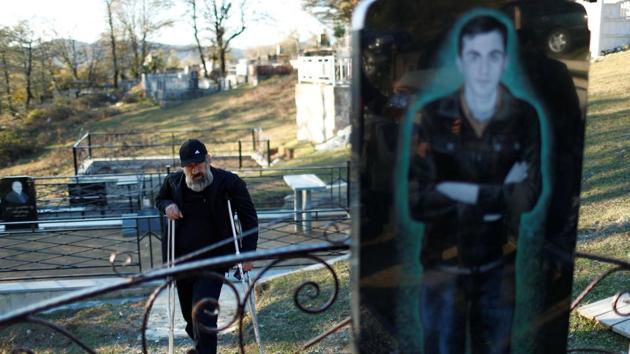 Retired miner Guram Gamezardashvili, 54, stands at a grave of his son Pavle who died during an accident at the mine. “There isn’t any other job in the town that’s why we all work at the mine. We need more attention from the government, the safety rules must be tightened. The closing of the mine is not a solution, so many people will starve in that case,” he said. (David Mdzinarishvili / REUTERS)