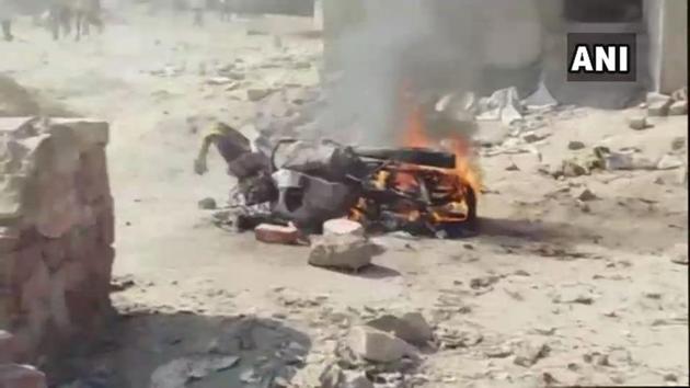 A motorcycle burning after a violent clash between workers of two different parties at a polling booth in Rajasthan’s Fatehpur town during voting for the assembly elections (ANI/Twitter)(ANI/Twitter)