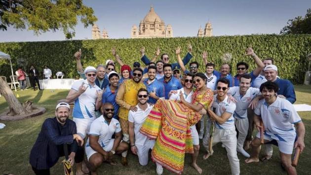 Bollywood actress Priyanka Chopra is lifted by Nick Jonas as they pose for a photograph with others after a cricket match, a day before their wedding, at Umaid Bhawan in Jodhpur, Rajasthan. (Raindrop Media / AP) Bollywood actress Priyanka Chopra is lifted by Nick Jonas as they pose for a photograph with others after a cricket match, a day before their wedding, at Umaid Bhawan in Jodhpur, Rajasthan. (Raindrop Media / AP)