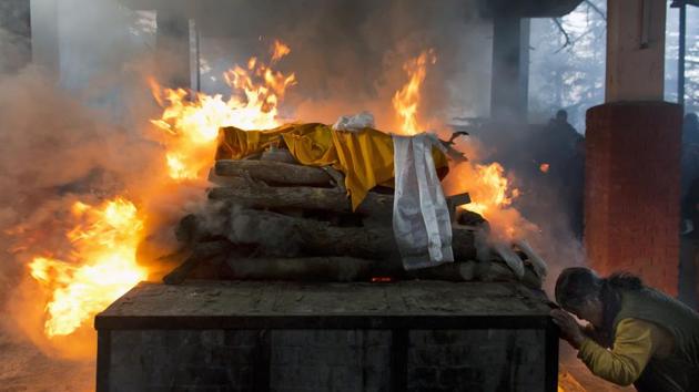 A Tibetan in exile pays her respects to the burning funeral pyre of Palden Gyatso in Dharmsala, Himachal Pradesh. Gyatso, a Tibetan Buddhist monk who spent more than 30 years in Chinese jails, died in Dharmsala on November 30. (Ashwini Bhatia / AP) A Tibetan in exile pays her respects to the burning funeral pyre of Palden Gyatso in Dharmsala, Himachal Pradesh. Gyatso, a Tibetan Buddhist monk who spent more than 30 years in Chinese jails, died in Dharmsala on November 30. (Ashwini Bhatia / AP)