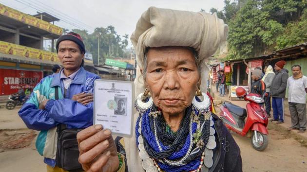 Mizoram exit polls 2018: Kanhmun: A Bru tribal woman shows her identity card as she waits to cast her vote at a polling station for the state Assembly elections, at Kanhmun, Mizoram.(PTI)