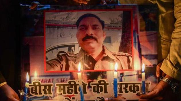 Allahabad: Samajwadi Party workers take part in a candle light march to pay tribute to police inspector Subodh Singh, who was killed in Monday's mob violence in Bulandshahr, in Allahabad.(PTI)