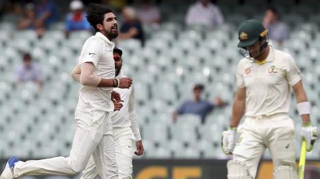 India's Ishant Sharma, left, celebrates after dismissing Australia's Tim Paine, right, during the first cricket test between Australia and India in Adelaide.(AP)