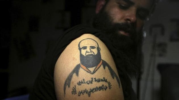 Zuhair Atwan displays tattoo of his brother, who was killed in sectarian violence, in a tattoo studio in Baghdad. The Arabic sentence on his arm reads, “Oh life, where is my brother? Your absence hurts me, oh Abbas.” (Hadi Mizban / AP) Zuhair Atwan displays tattoo of his brother, who was killed in sectarian violence, in a tattoo studio in Baghdad. The Arabic sentence on his arm reads, “Oh life, where is my brother? Your absence hurts me, oh Abbas.” (Hadi Mizban / AP)