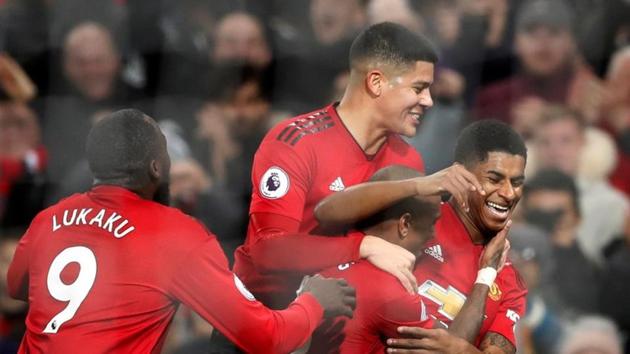 Manchester United's Marcus Rashford celebrates scoring their fourth goal with team mates.(euters)