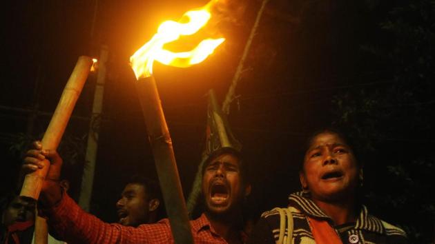 BJP supporters stage a torch rally against the attack on party’s West Bengal unit chief Dilip Ghosh allegedly by Trinamool Congress goons ahead of Rath Yatra in Cooch Behar on Thursday.(Samir Jana/HT PHOTO)